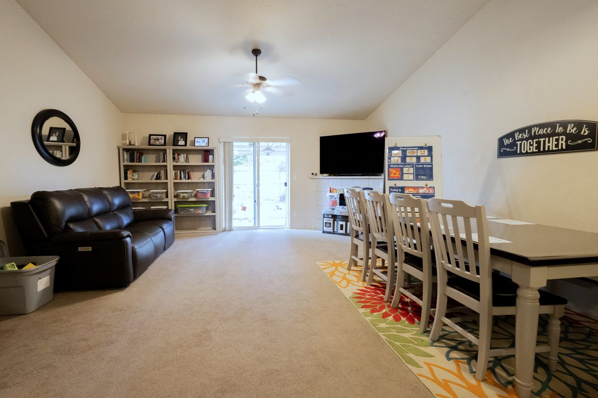 Living room with bookshelves, seating, and the group table