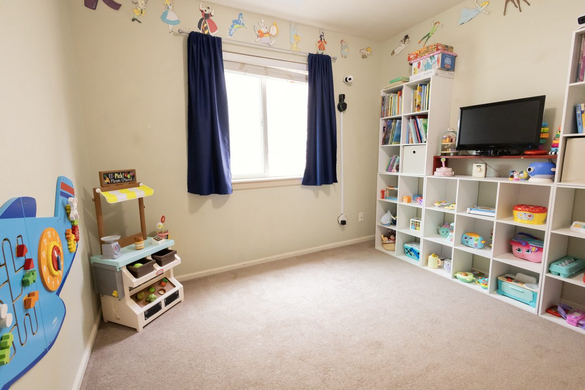 Playroom with open cube shelving and a reading corner