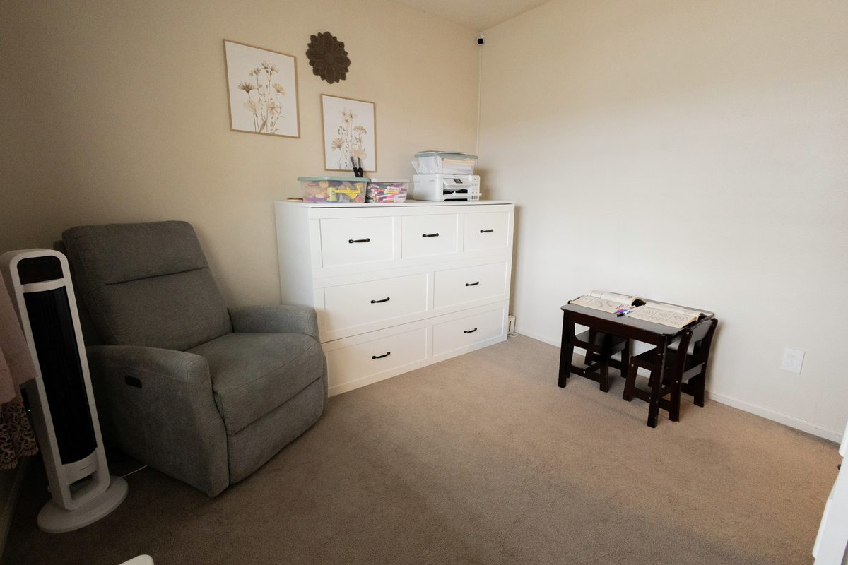 Second playroom with a rocking recliner and a small activity table