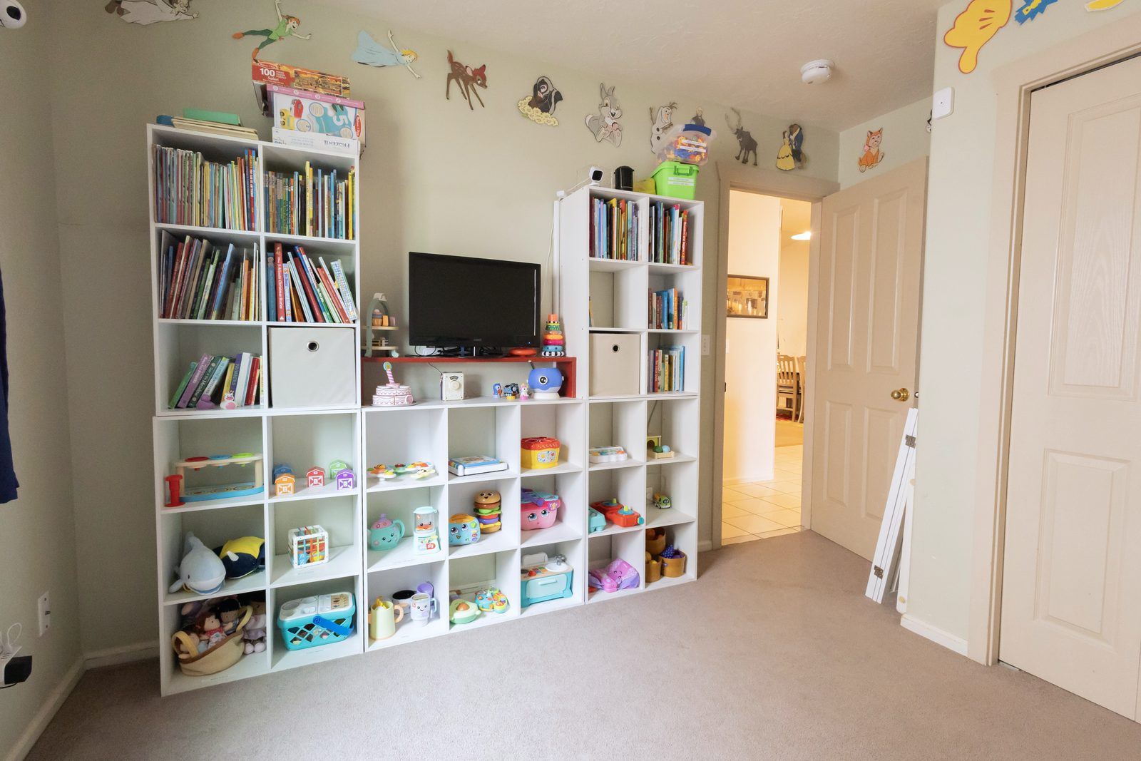 Playroom with floor-to-ceiling shelves of books and toys